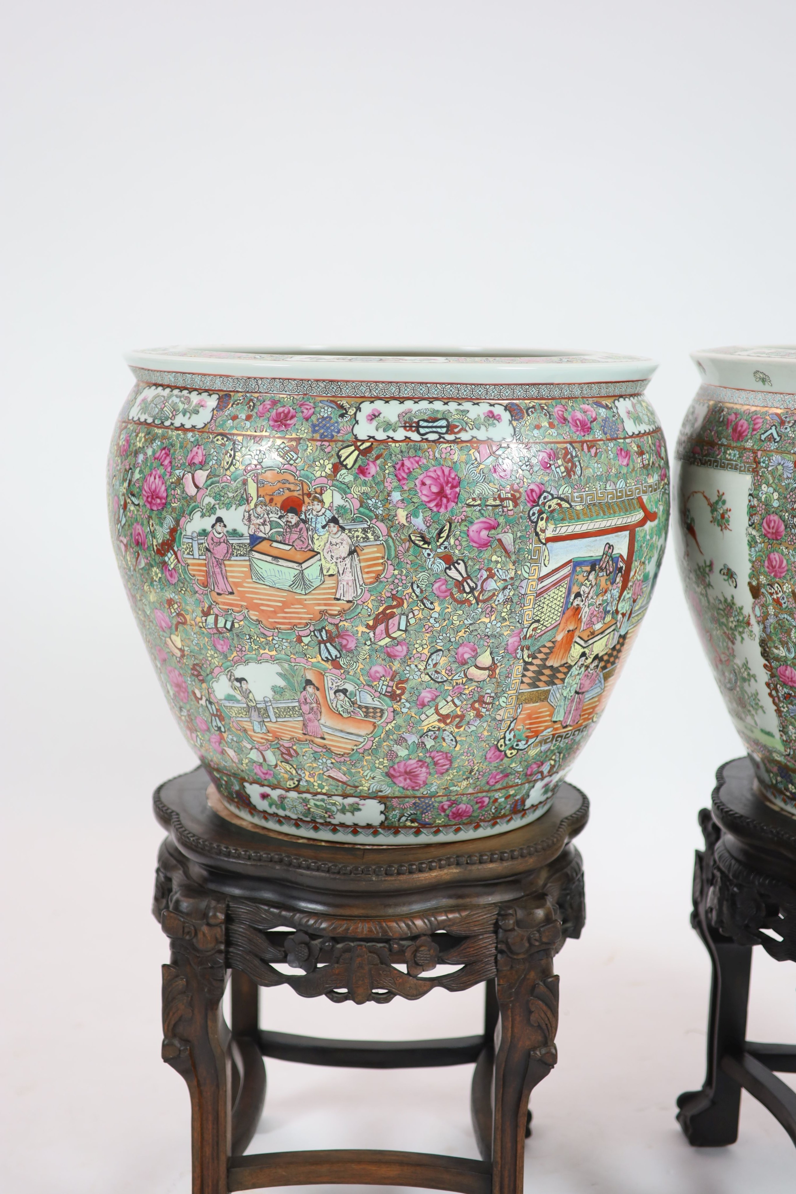 A pair of Chinese famille rose gold fish bowls, 56cm diameter with ebonised and marble inset stands, total height 91cm